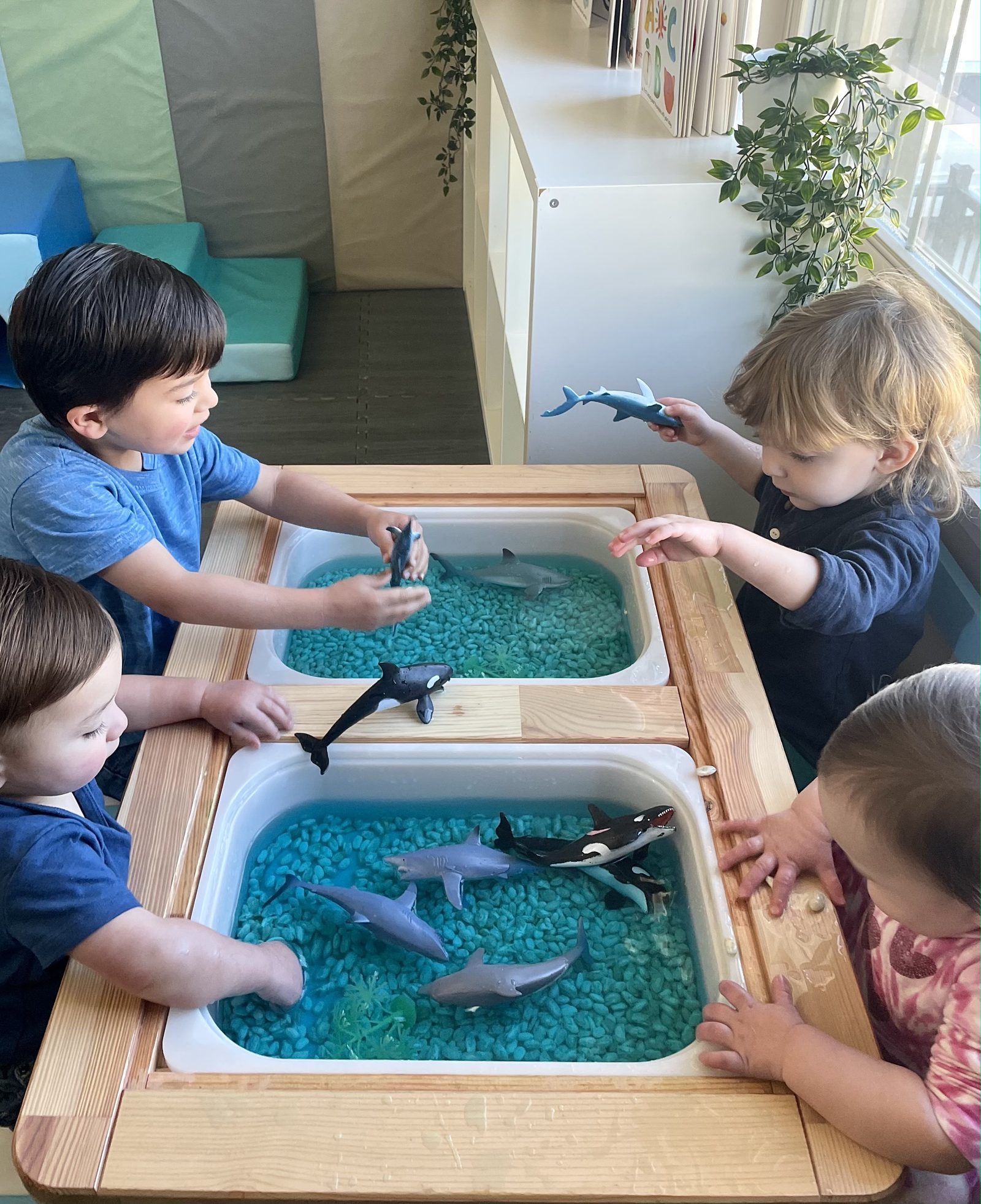 Ocean-themed sensory table with toy sea animals